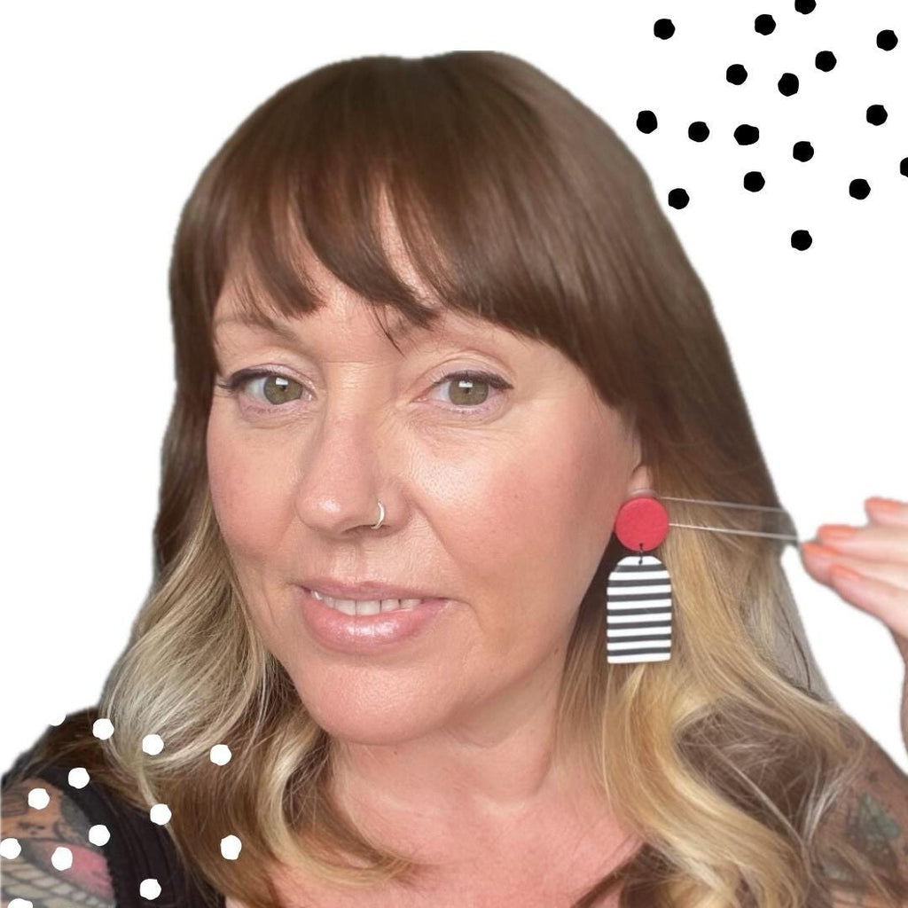 Picture of Kerry from Kay Jay Clay trying on the Black and white striped earrings with red top for size reference