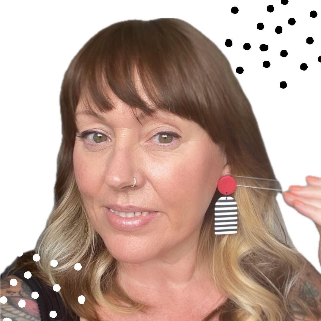 Picture of Kerry from Kay Jay Clay trying on the Black and white striped earrings with red top for size reference