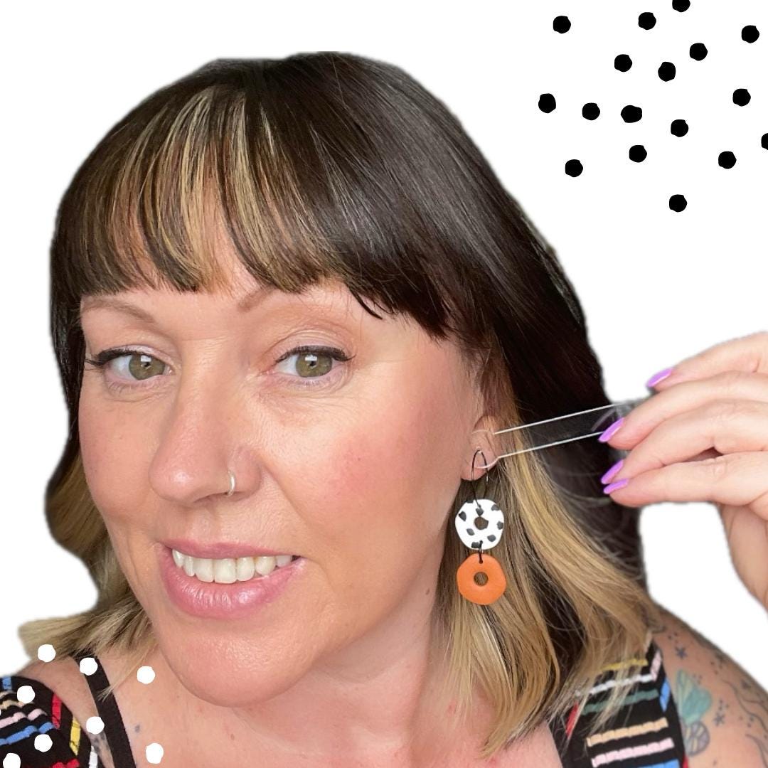 try on picture of Kerry from Kay Jay Clay wearing the Burnt orange & Dalmatian print hoop earrings for size reference