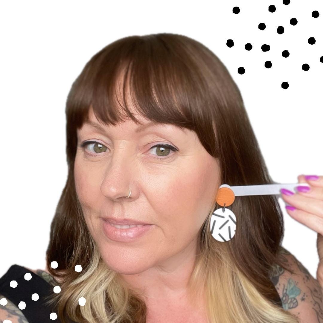 Try on picture of Kerry from Kay Jay Clay wearing the burnt orange top & mono sprinkle oval bottom earrings for size reference