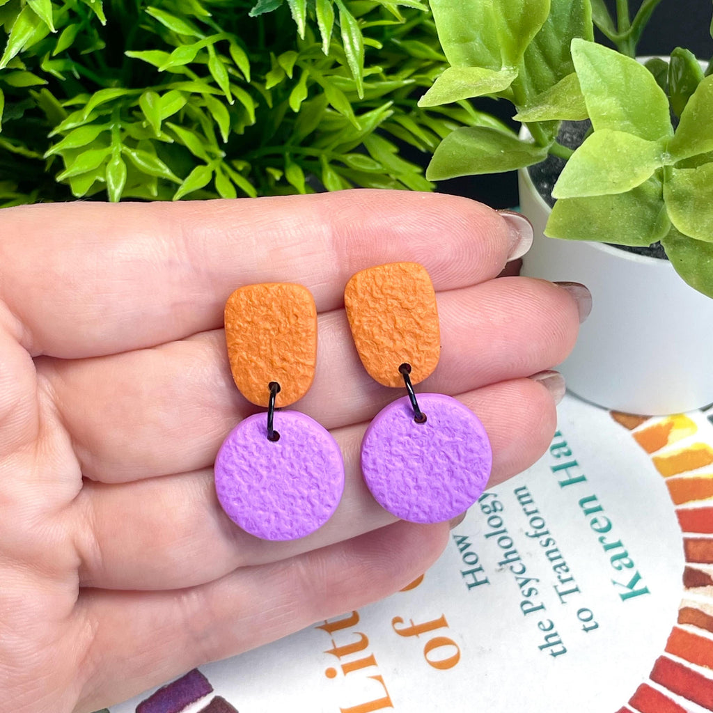 Colour block dangle earrings - burnt orange & lilac hand held