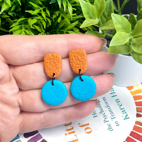 Colour block dangle earrings - burnt orange & turquoise hand held