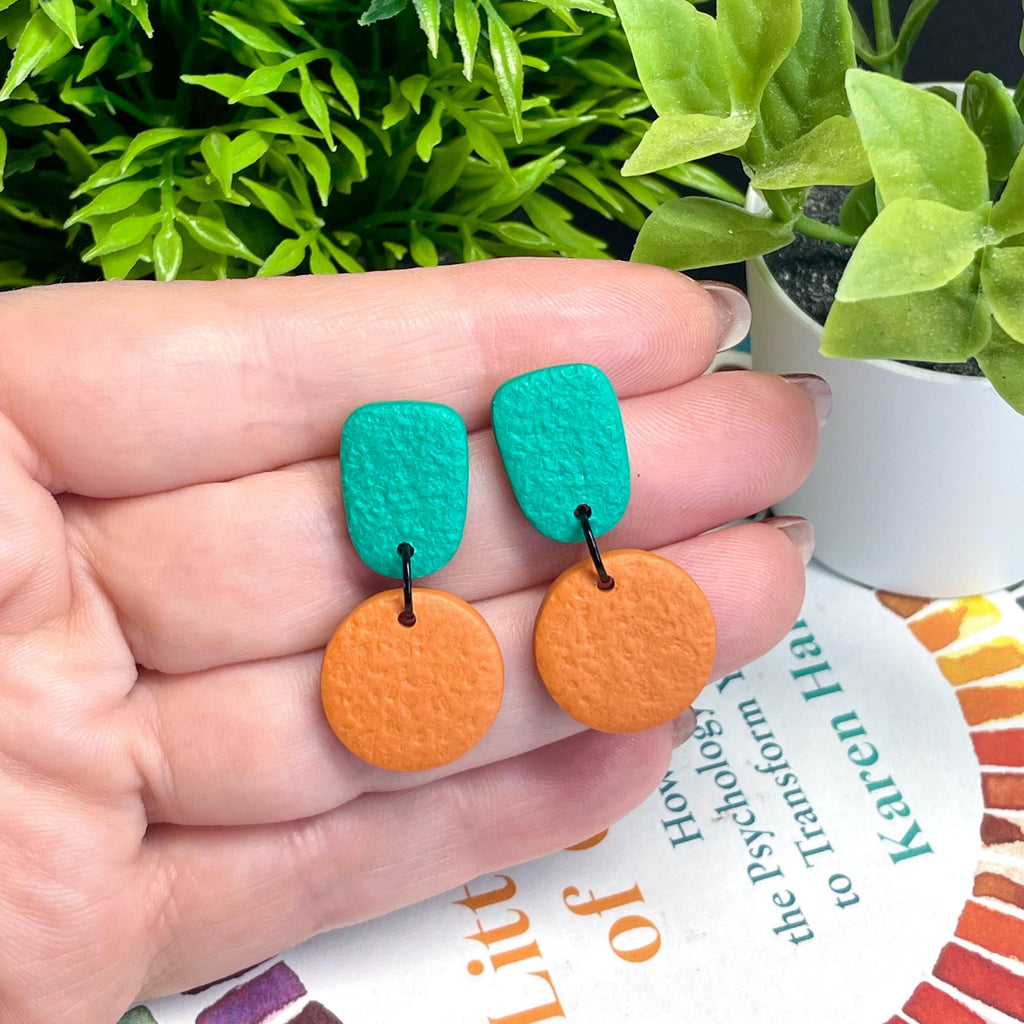 Colour block dangle earrings - emerald green and burnt orange hand held