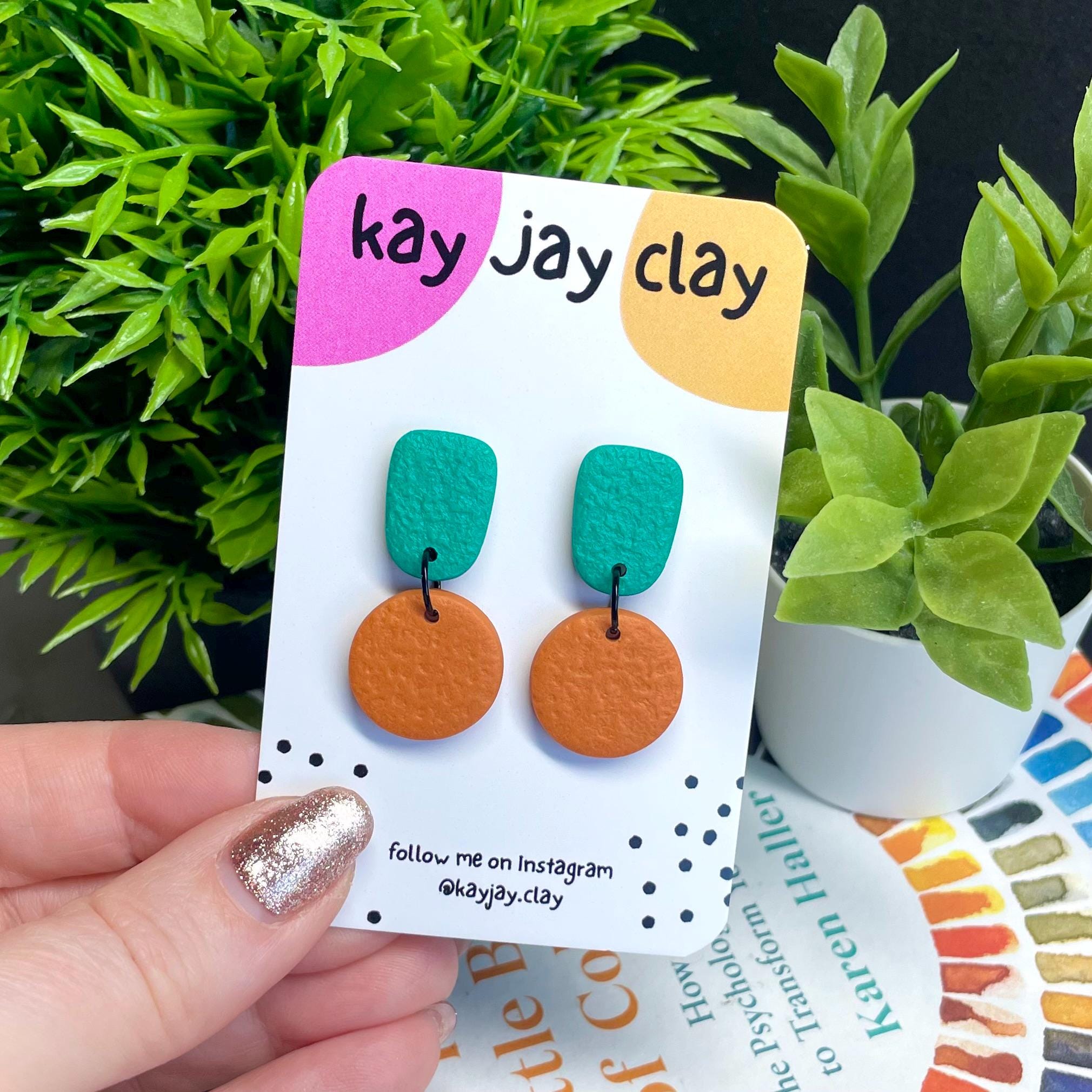 Colour block dangle earrings - emerald green and burnt orange on mounting card