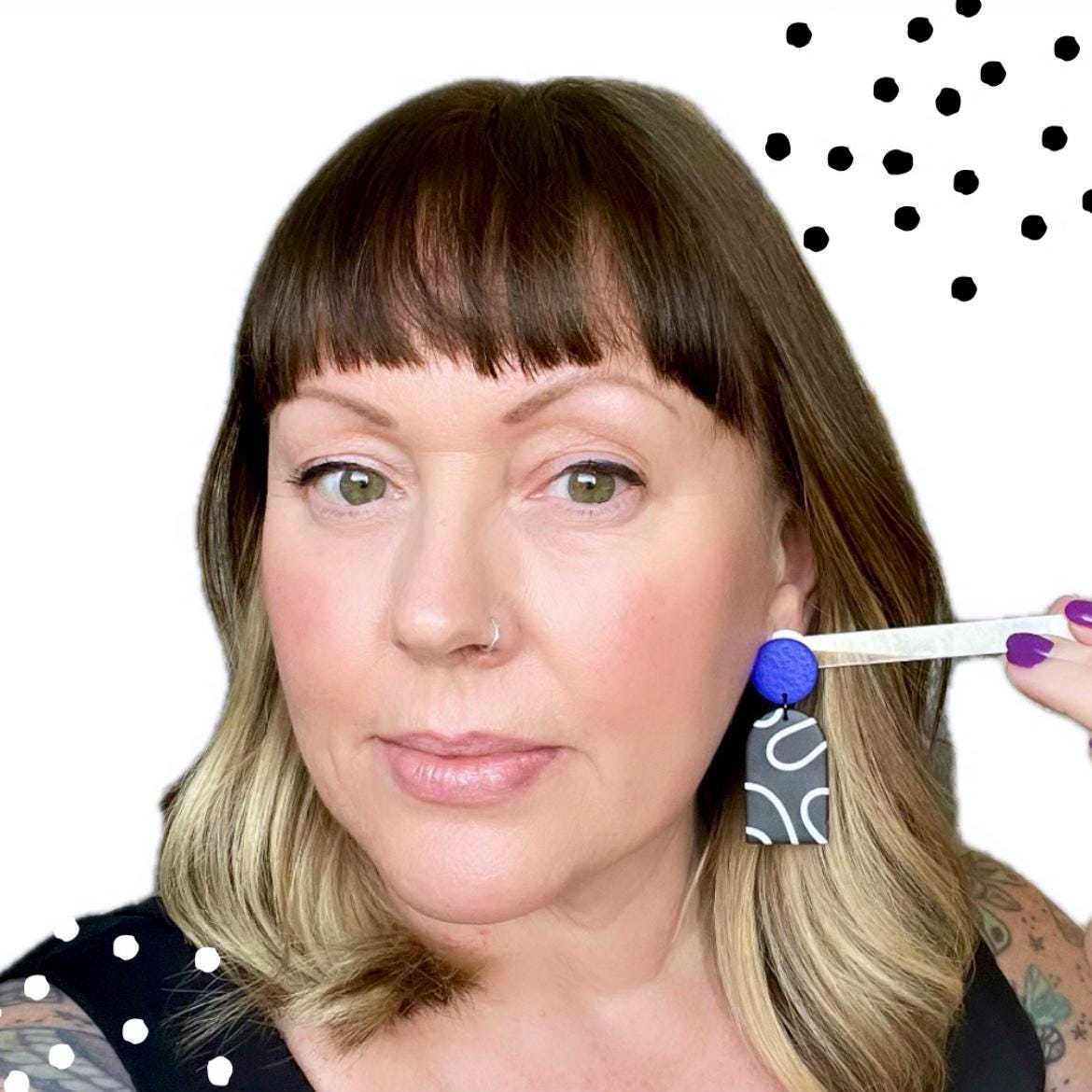 Try on picture of Kerry from Kay Jay Clay wearing the monochrome squiggle dangle earrings with an electric blue top for size reference