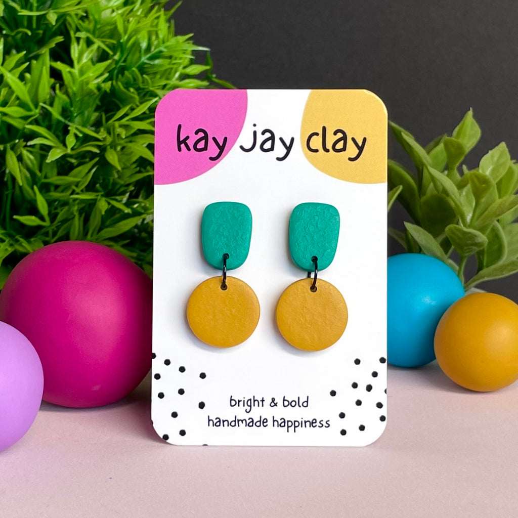 Emerald Green & Mustard Yellow colour pop dangle earrings on Kay Jay Clay branded mounting card
