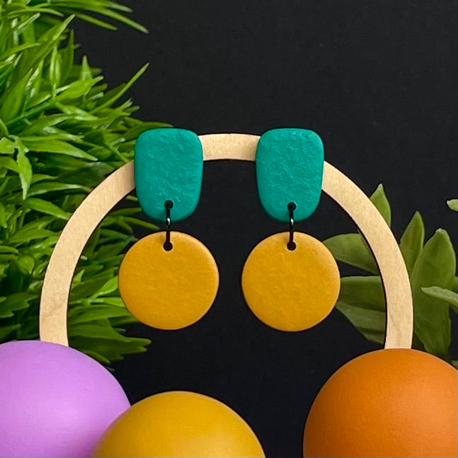 Emerald Green & Mustard Yellow colour pop dangle earrings on hoop display prop