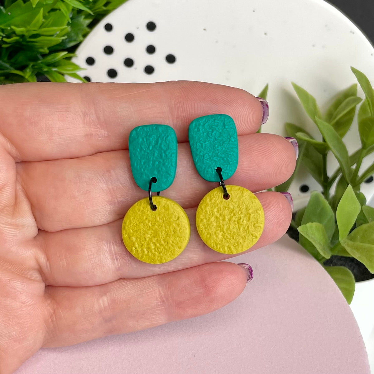 Emerald & Pistachio Green colour pop dangle earrings held in hand for size reference