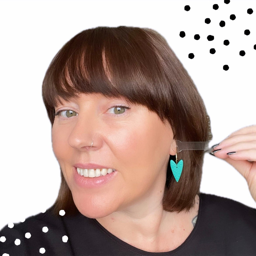 Try on picture showing me wearing the green heart hoop earrings for size reference