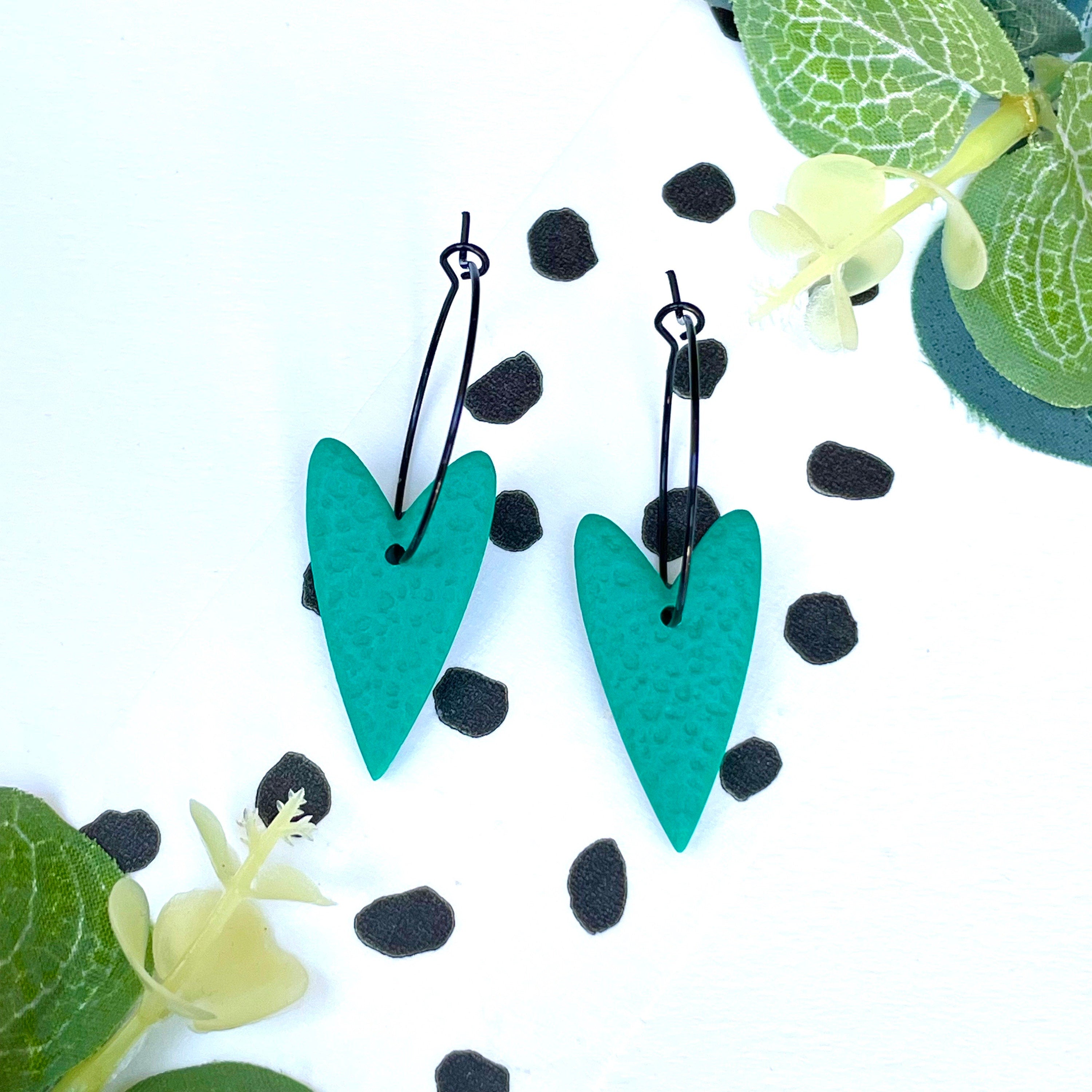 Emerald green polymer clay heart hoop earrings on a black colour hoop