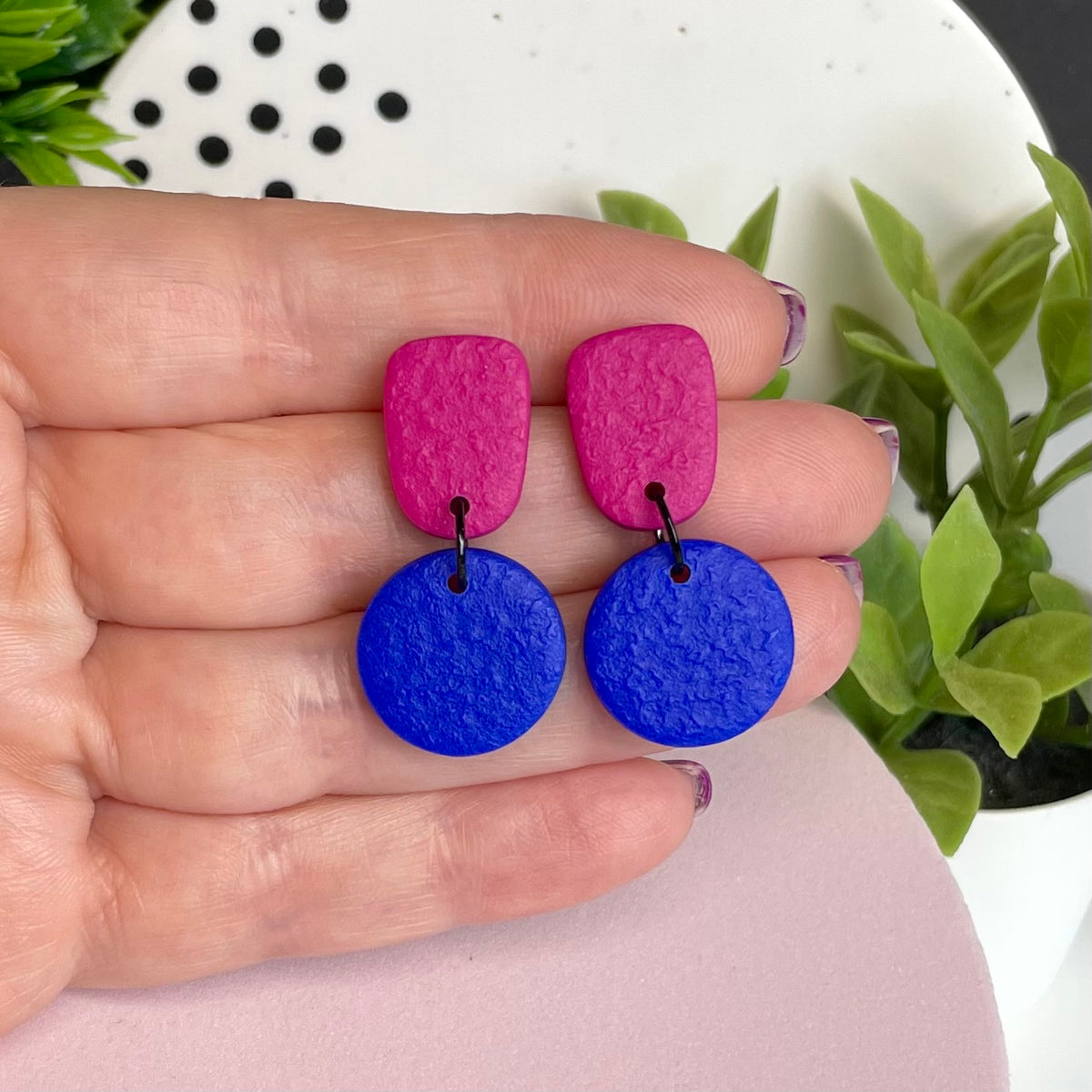 Hot Pink & Electric Blue colour pop dangle earrings held in hand for size reference