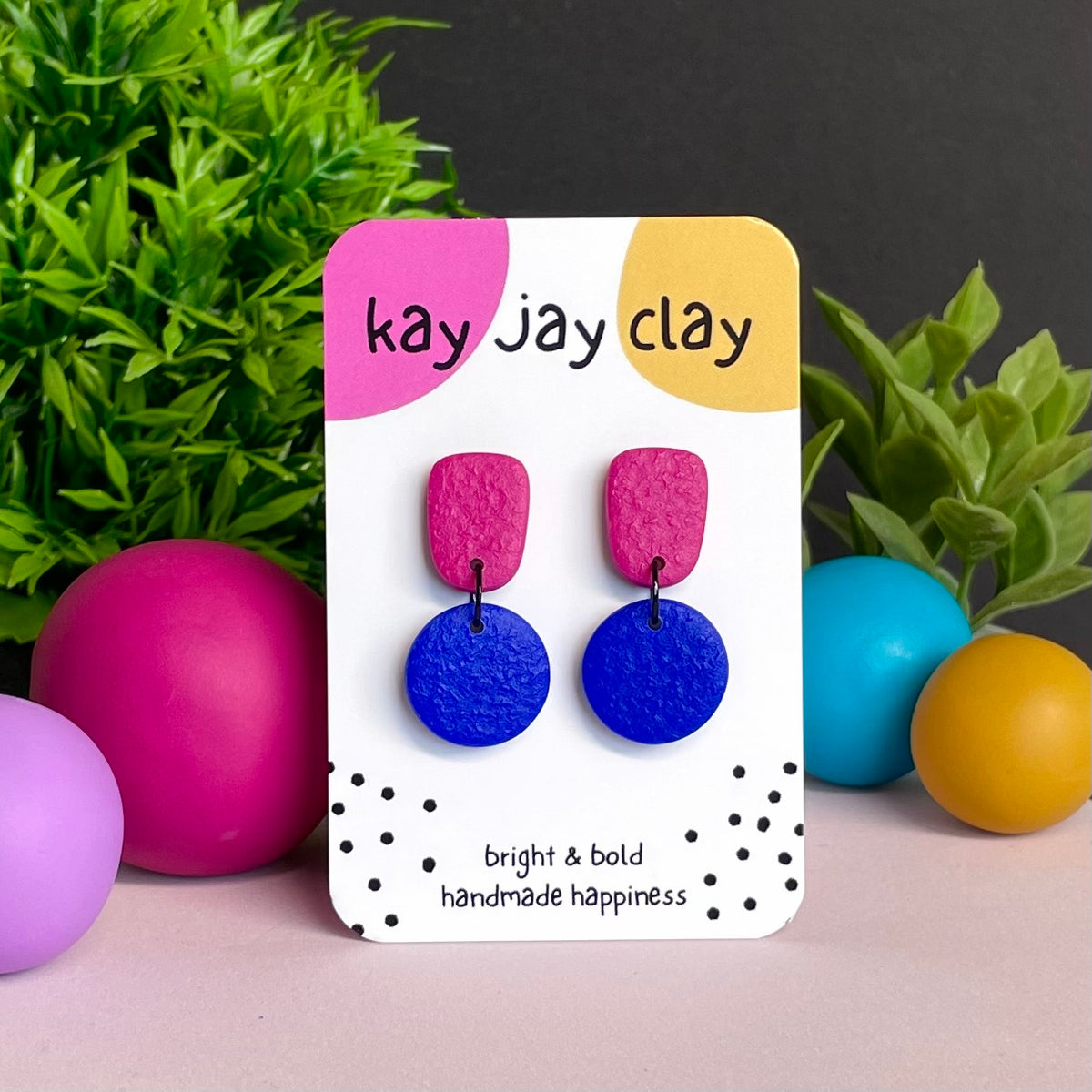 Hot Pink & Electric Blue colour pop dangle earrings on Kay Jay Clay branded mounting card
