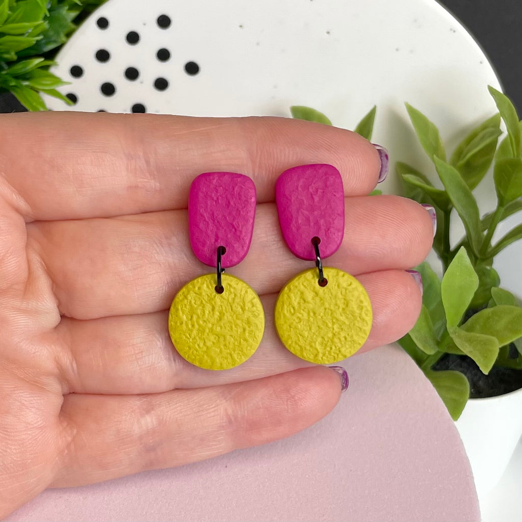 Hot Pink & Pistachio Green colour pop dangle earrings held in hand for size reference