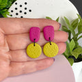 Hot Pink & Pistachio Green colour pop dangle earrings held in hand for size reference