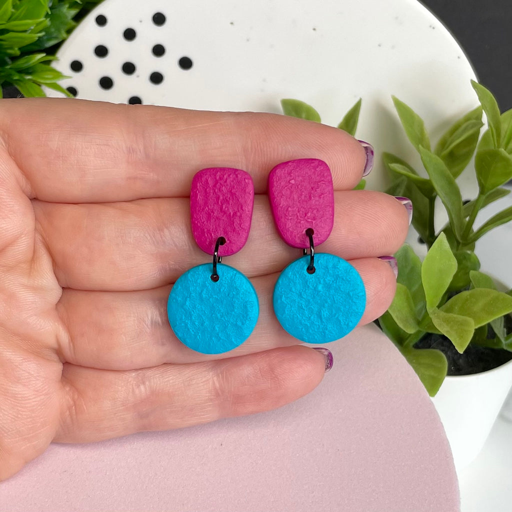 Hot Pink & Turquoise colour pop dangle earrings held in hand for size reference