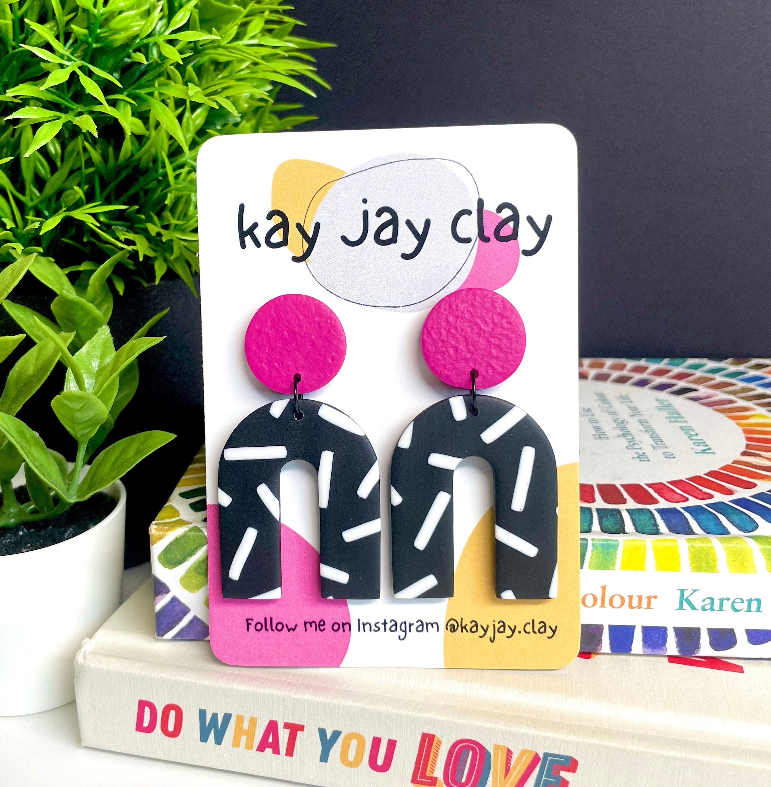 Hot pink and monochrome sprinkles arch dangle earrings On a Kay jay clay mounting card