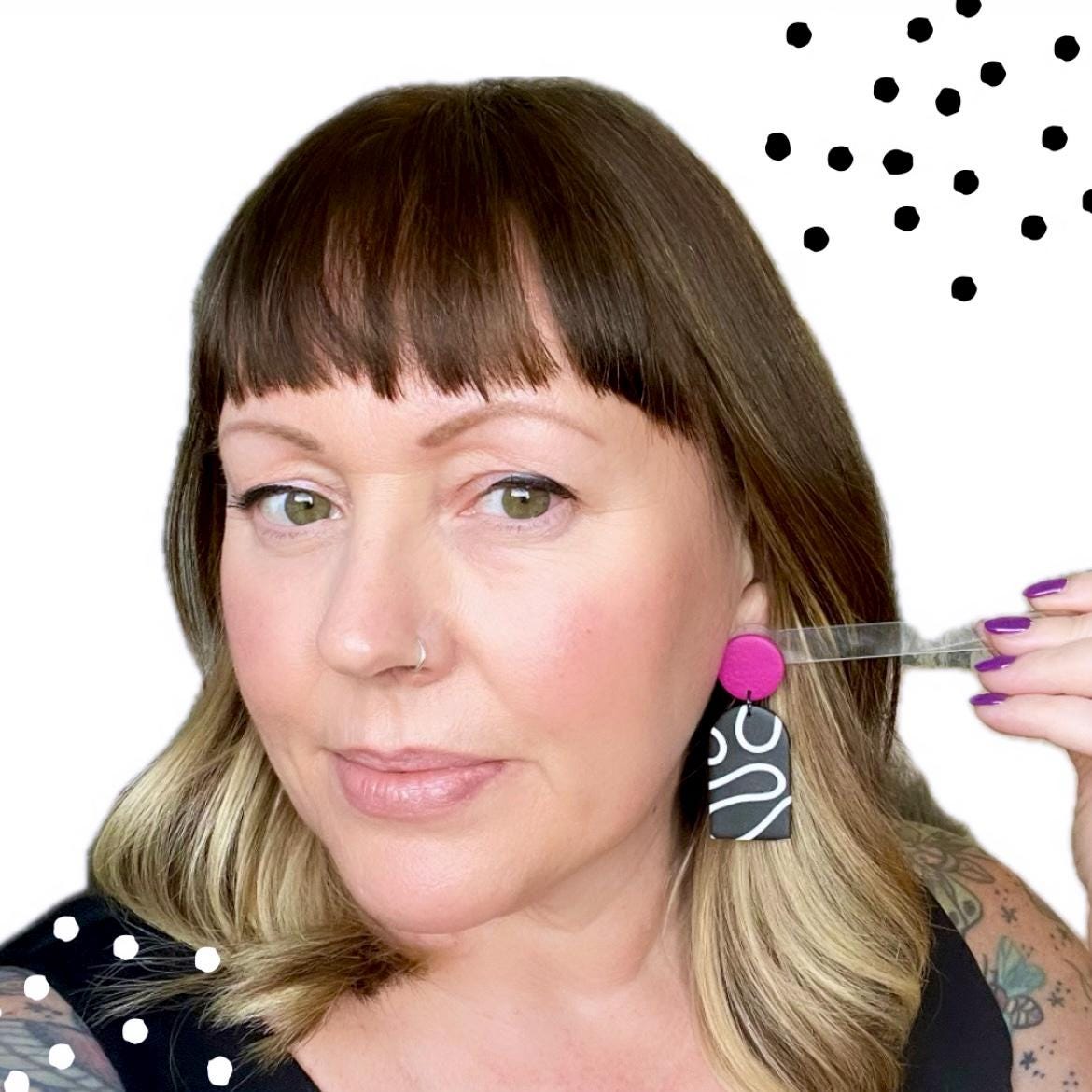 Try on picture of Kerry from Kay Jay Clay wearing the monochrome squiggle dangle earrings with hot pink tops for size reference