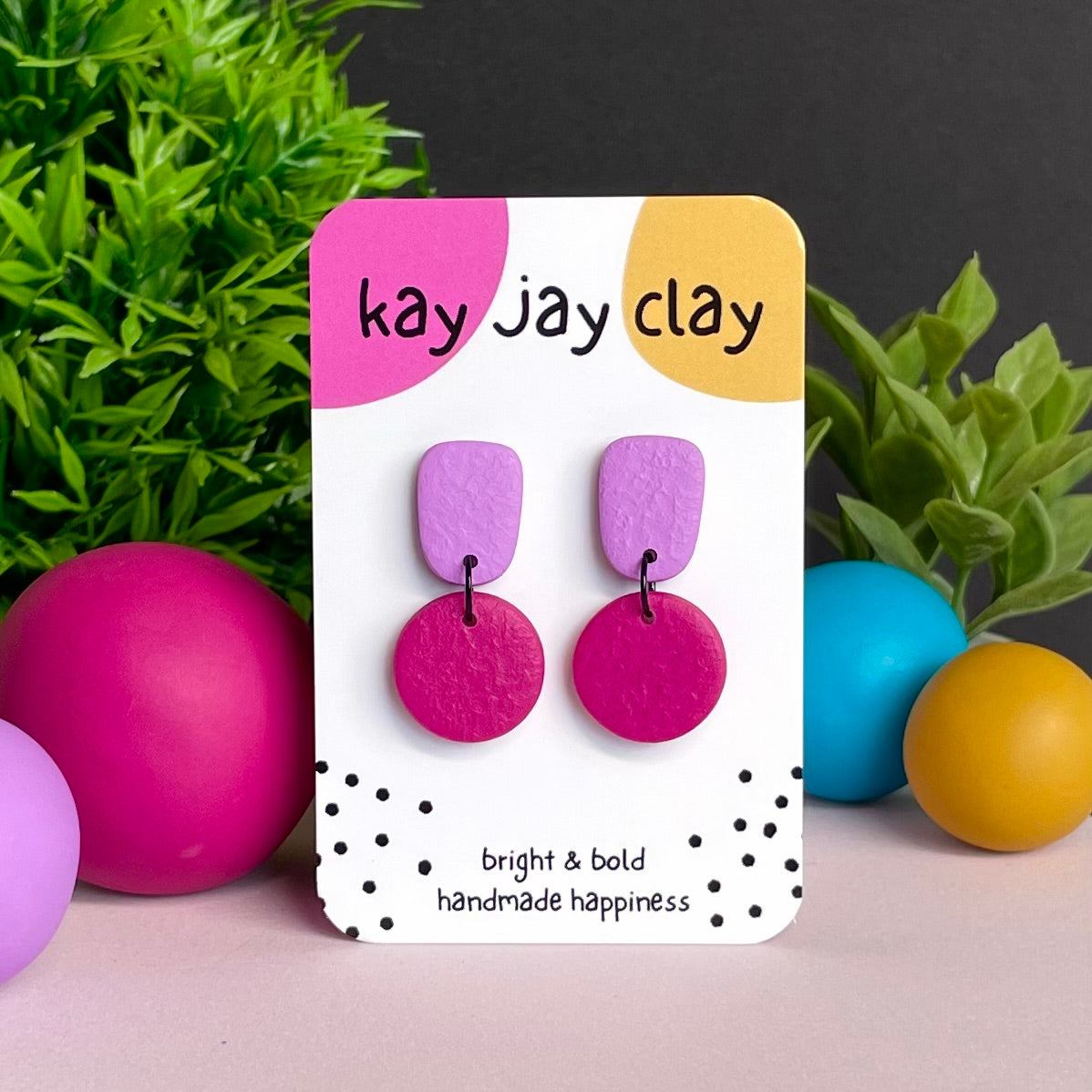 Lilac & Hot Pink colour pop dangle earrings on Kay Jay Clay branded mounting card