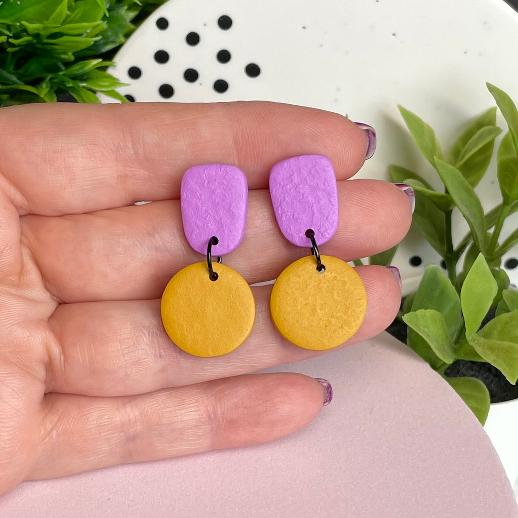 Lilac & Mustard Yellow colour pop dangle earrings held in hand for size reference