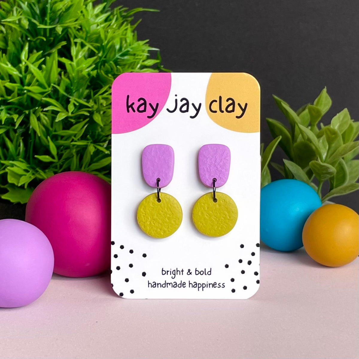 Lilac & Pistachio Green colour pop dangle earrings on Kay Jay Clay branded mounting card