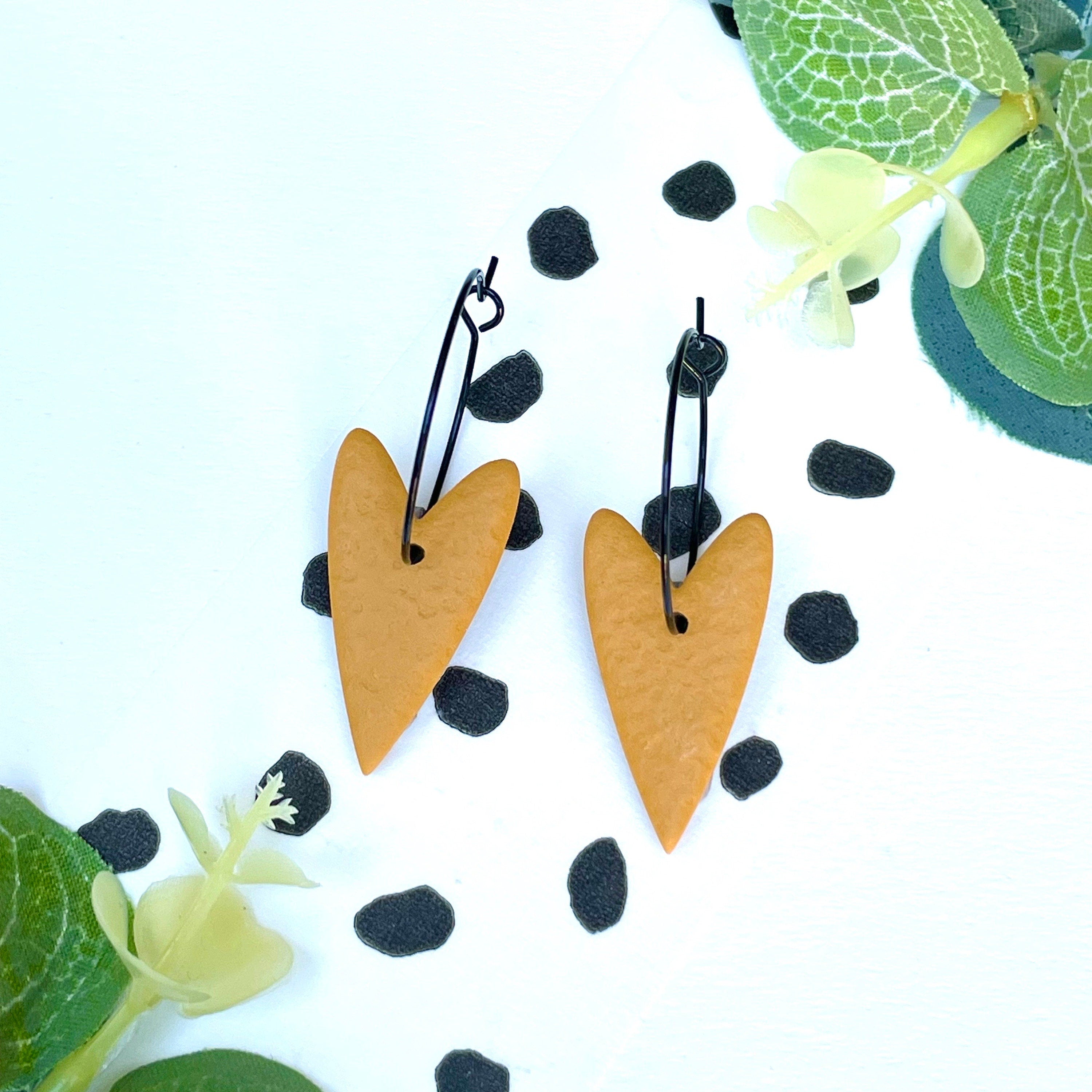 Mustard yellow heart earrings on black colour hypoallergenic hoops