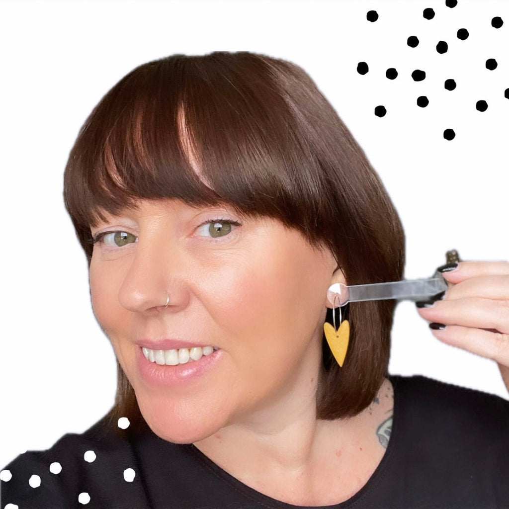 Try on picture of me wearing the yellow heart hoop earrings for size reference
