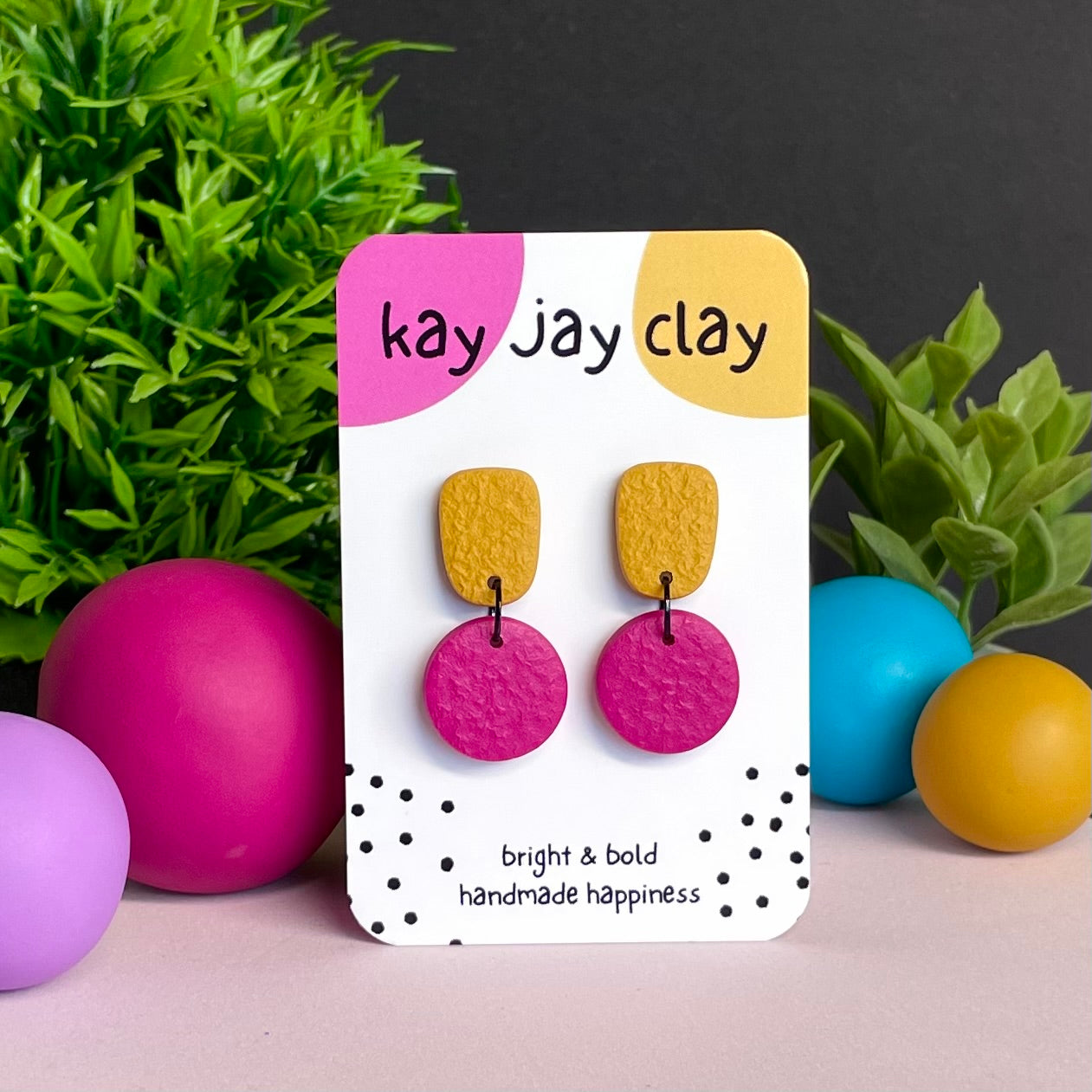 Mustard Yellow & Hot Pink colour pop dangle earrings on Kay Jay Clay branded mounting card