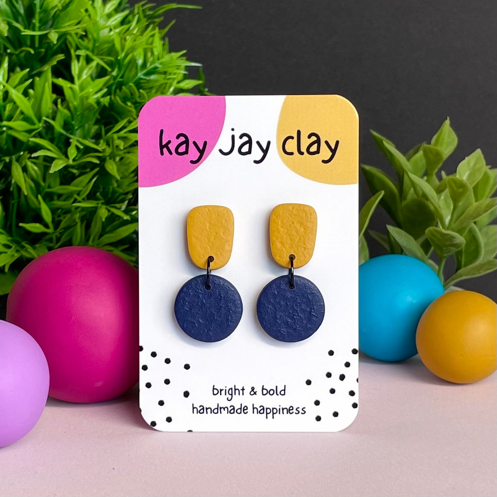 Mustard Yellow & Navy Blue colour pop dangle earrings on Kay Jay Clay branded mounting card