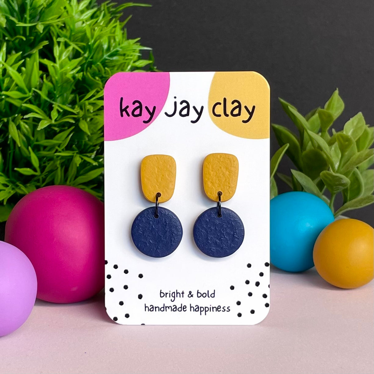 Mustard Yellow & Navy Blue colour pop dangle earrings on Kay Jay Clay branded mounting card