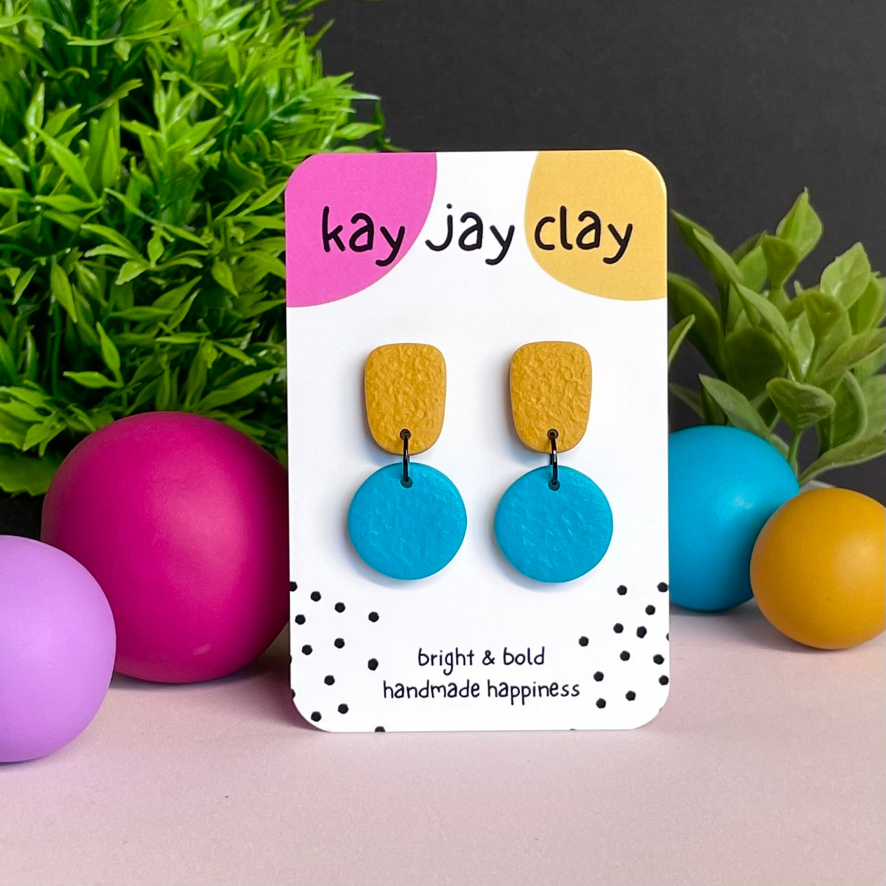 Mustard Yellow & Turquoise colour pop dangle earrings on Kay Jay Clay branded mounting card