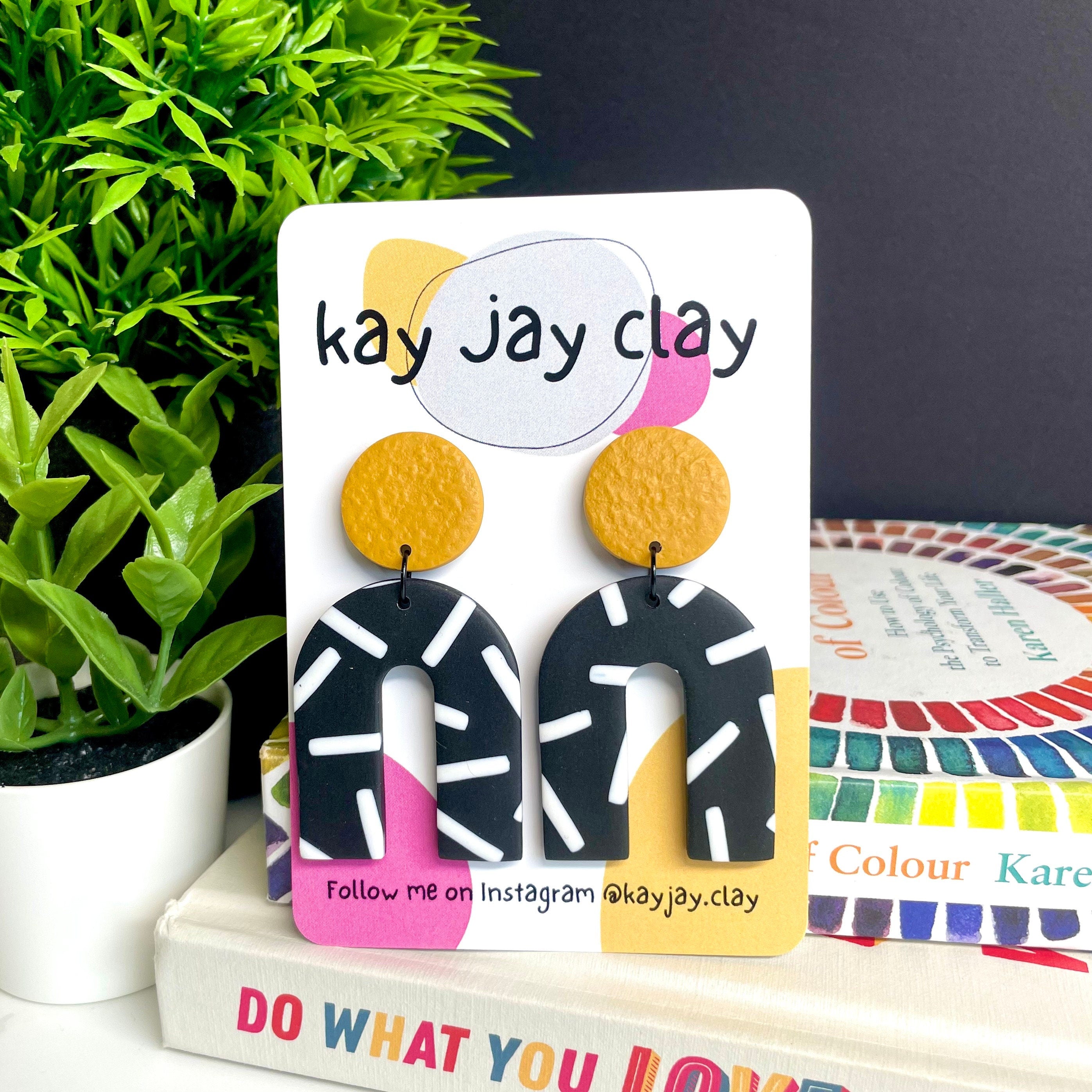 Mustard Yellow and monochrome sprinkles arch dangle earrings on a Kay jay clay mounting card