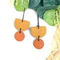 Mustard yellow & orange hoop earrings with black hoops 