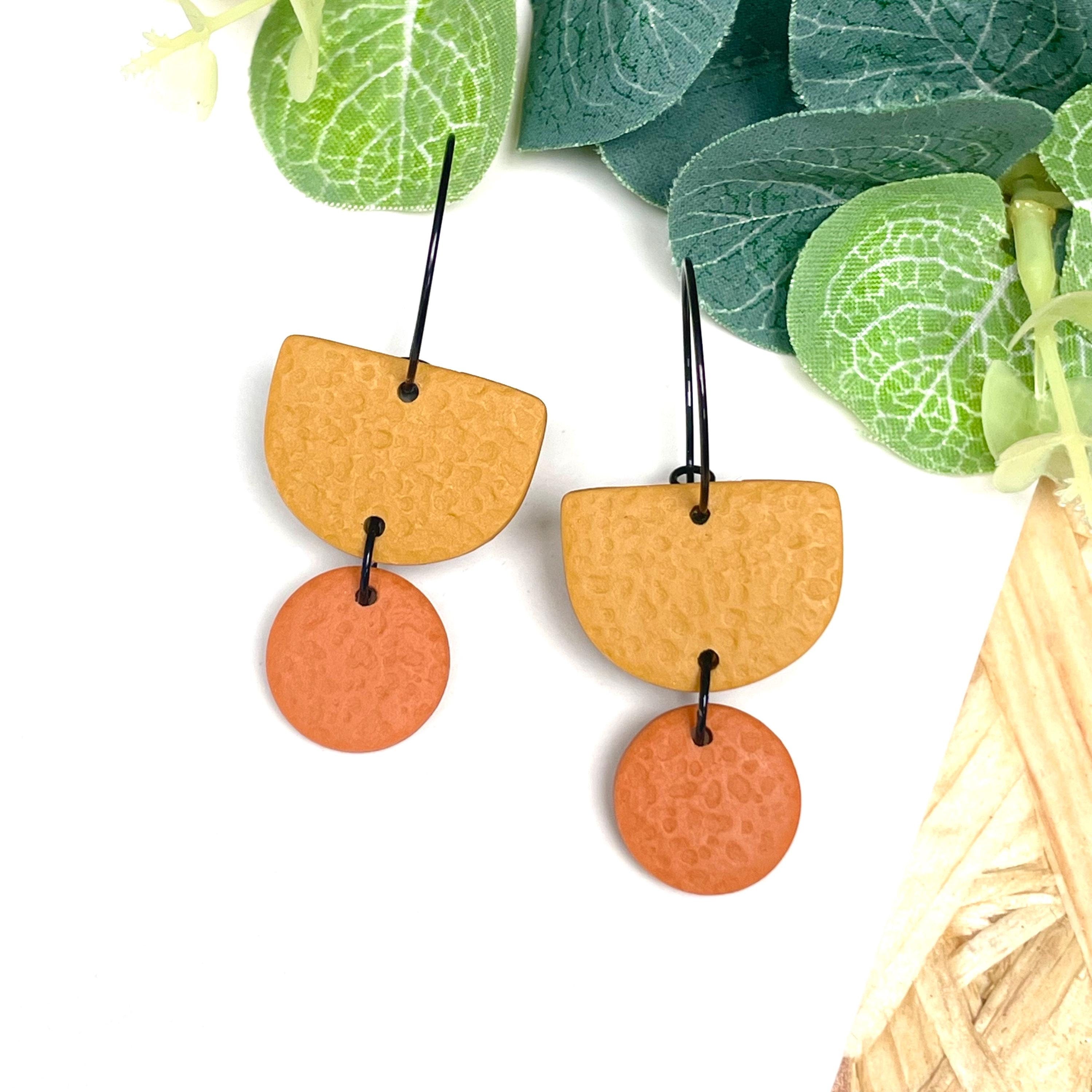 Mustard yellow & orange hoop earrings with black hoops 