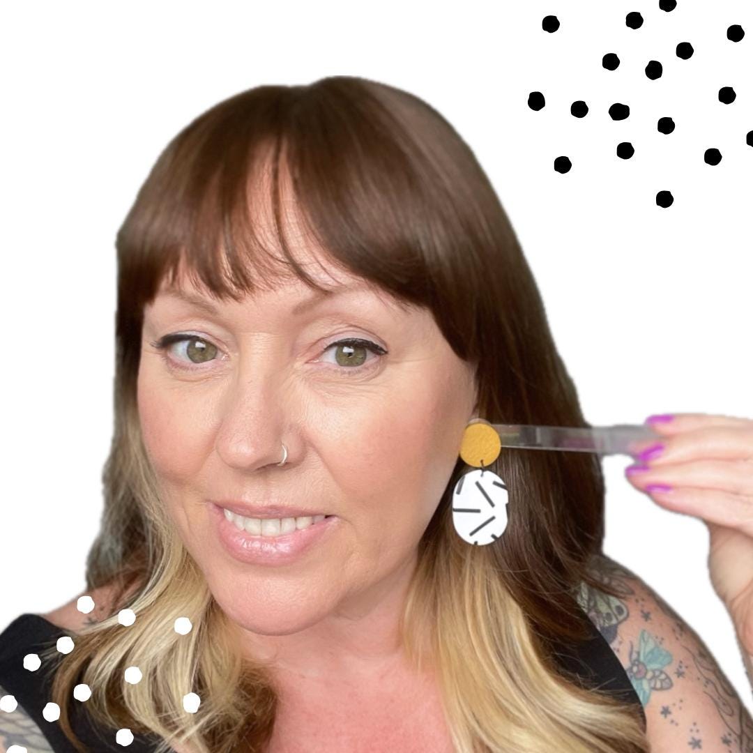 Try on picture of Kerry from Kay Jay Clay wearing the mustard yellow top & monochrome sprinkle oval bottom earrings for size reference