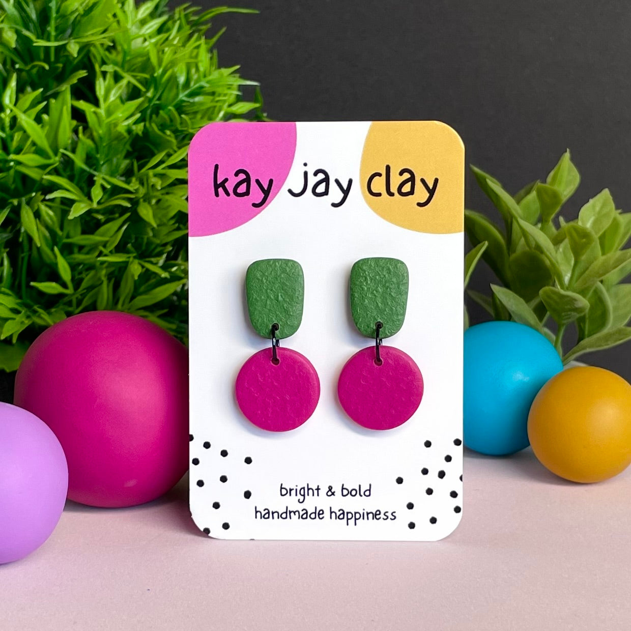 Olive Green & Hot Pink colour pop dangle earrings on Kay Jay Clay branded mounting card