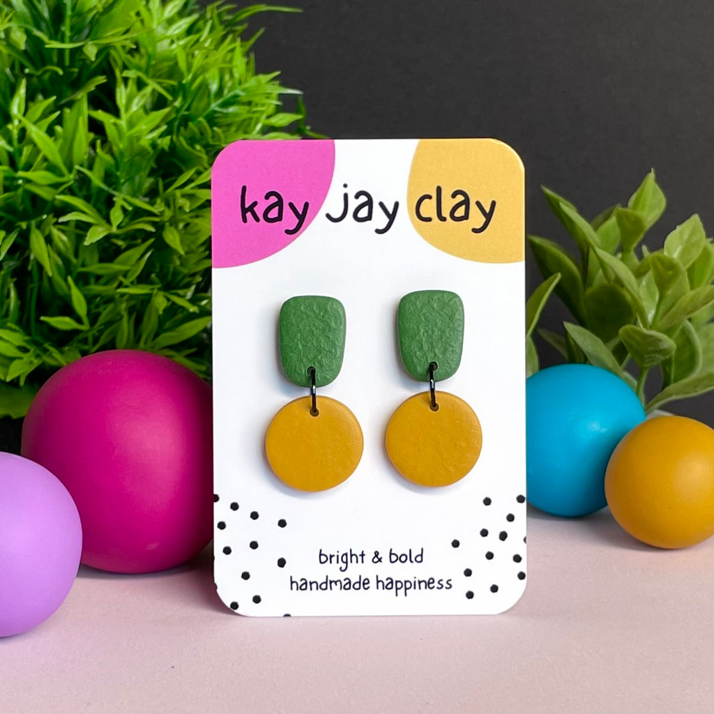 Olive Green & Mustard Yellow colour pop dangle earrings on Kay Jay Clay branded mounting card