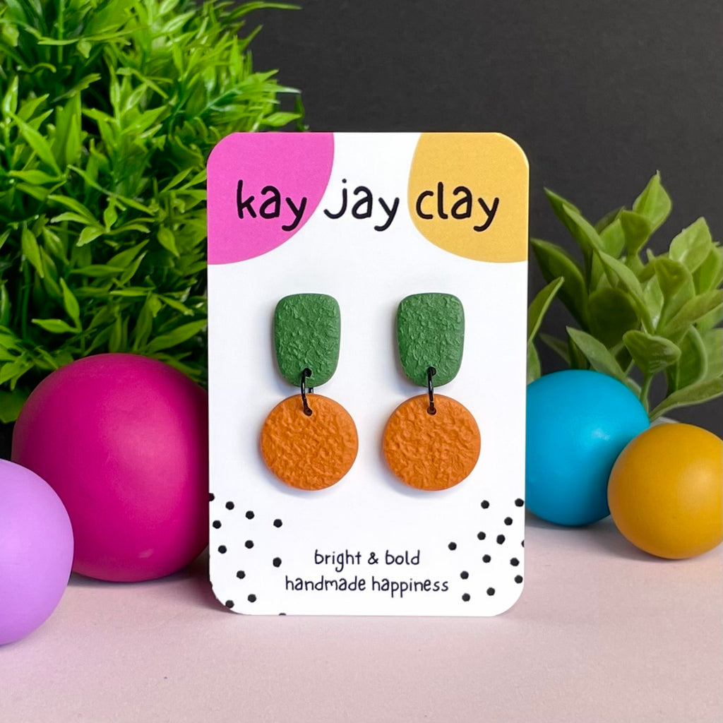 Olive Green & Orange colour pop dangle earrings on Kay Jay Clay branded mounting card