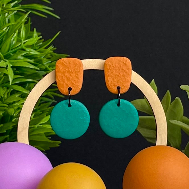 Orange & Emerald Green colour pop dangle earrings on hoop display prop