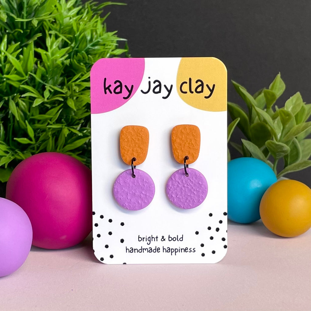 Orange & Lilac colour pop dangle earrings on Kay Jay Clay branded mounting card