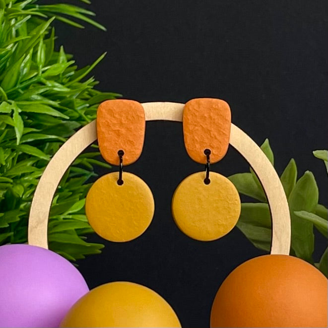 Orange & Mustard Yellow colour pop dangle earrings on hoop display prop