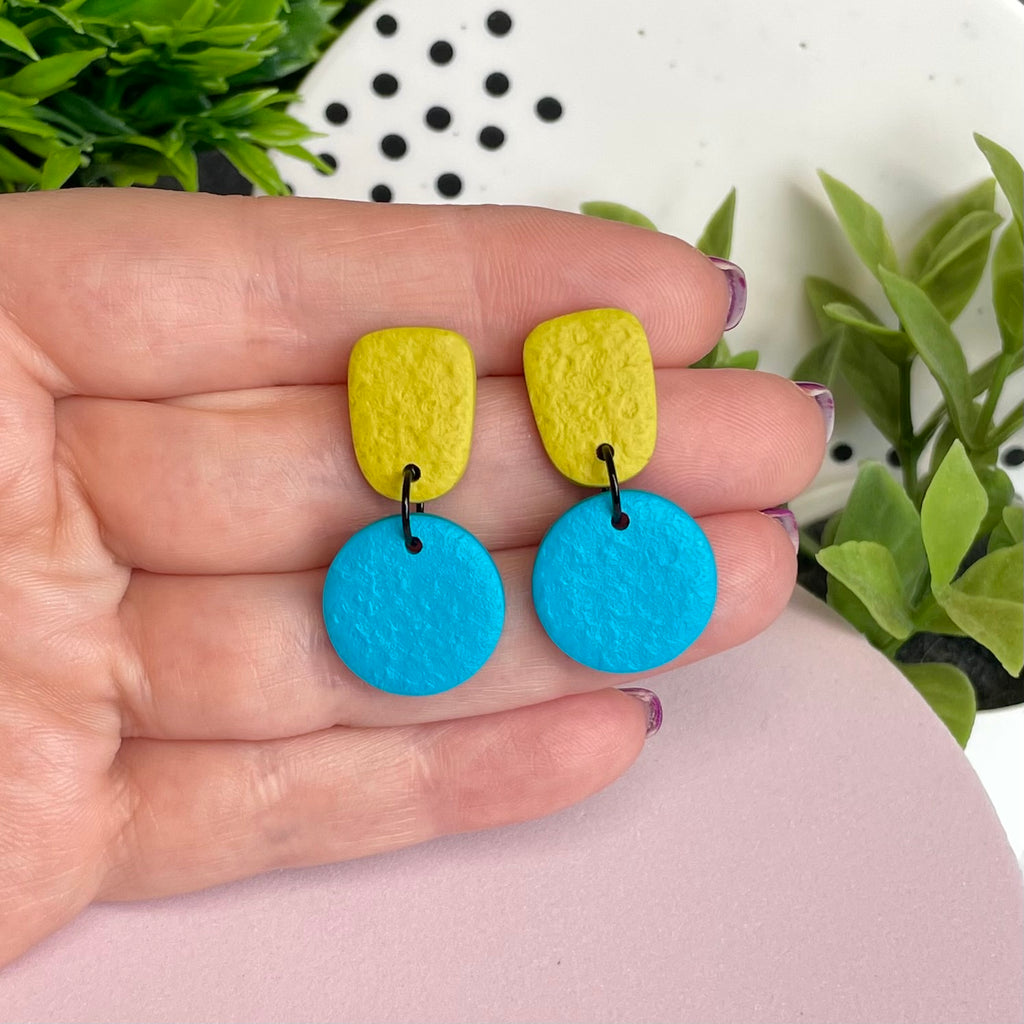 Pistachio Green & Turquoise colour pop dangle earrings held in hand for size reference
