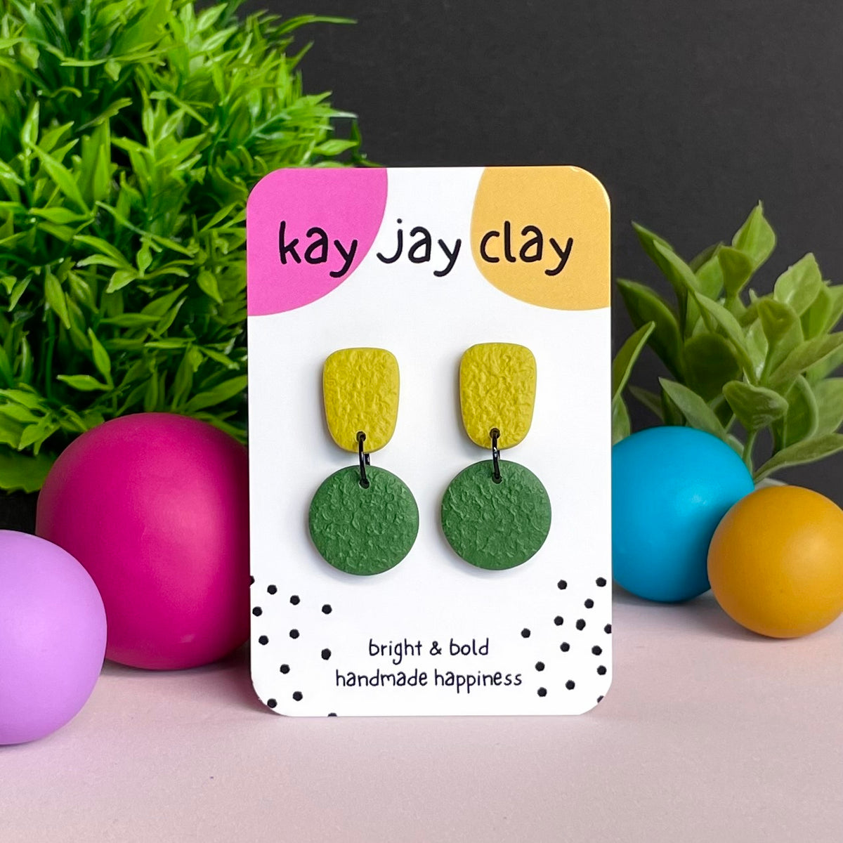 Pistachio & Olive Green colour pop dangle earrings on Kay Jay Clay branded mounting card