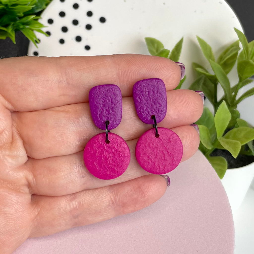 Purple & Hot Pink colour pop dangle earrings held in hand for size reference