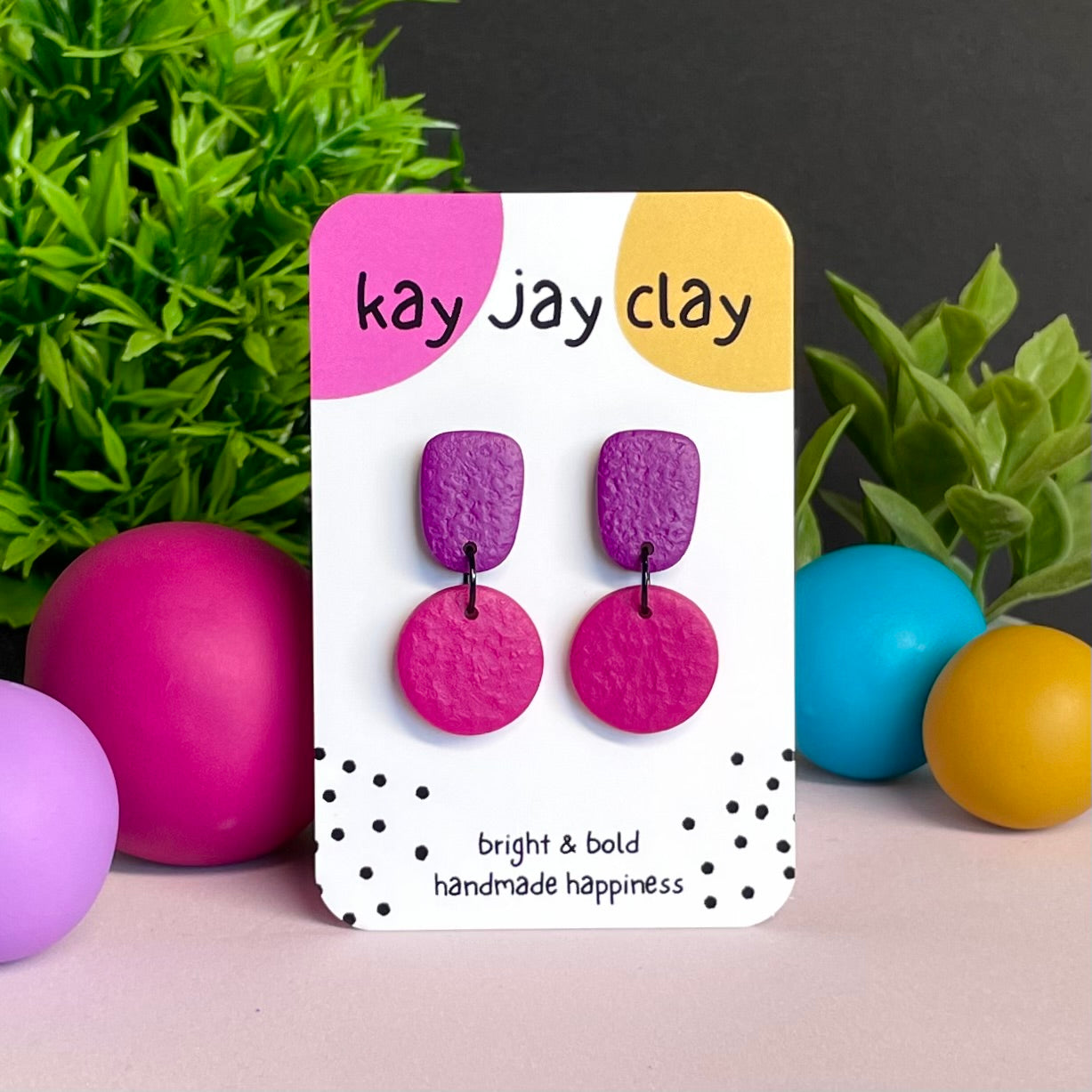 Purple & Hot Pink colour pop dangle earrings on Kay Jay Clay branded mounting card