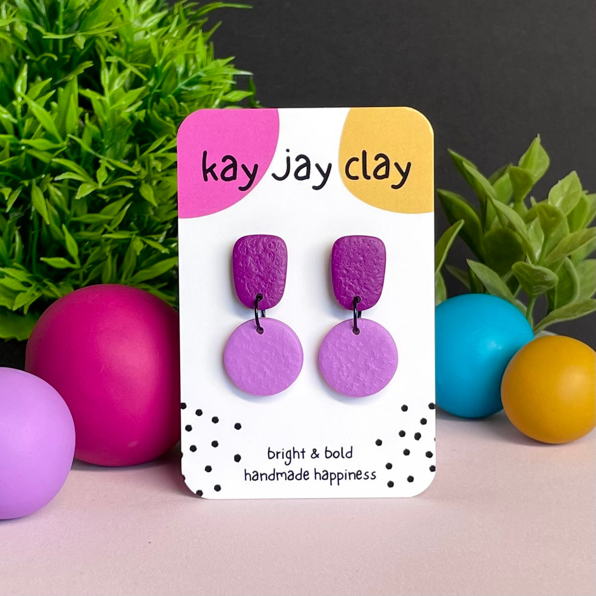 Purple & Lilac colour pop dangle earrings on Kay Jay Clay branded mounting card