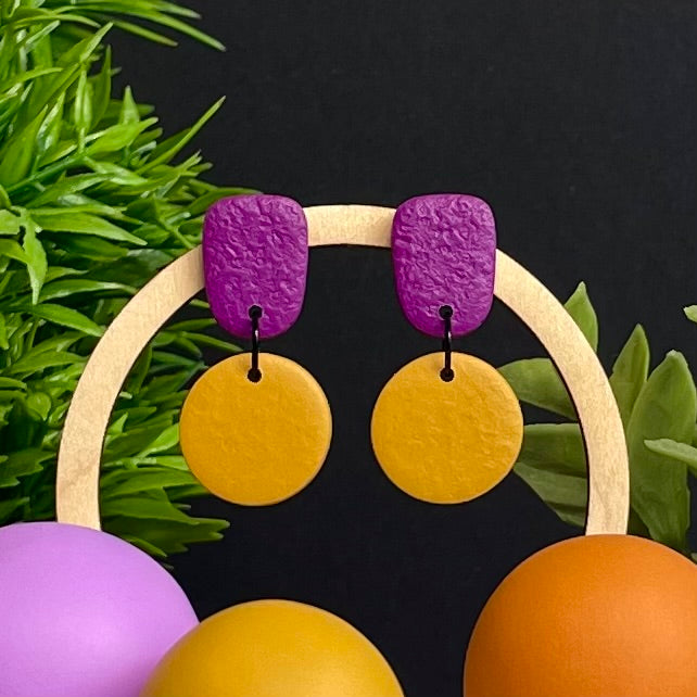 Purple & Mustard Yellow colour pop dangle earrings on hoop display prop