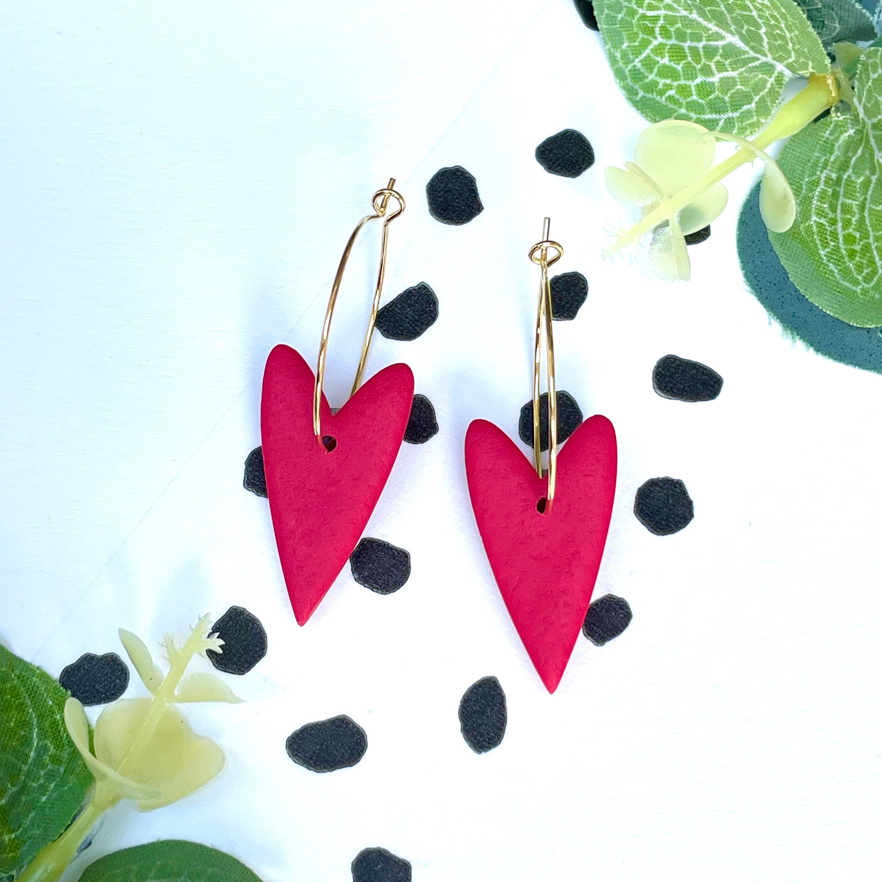 Bright red heart hoop earrings on a gold colour hoop