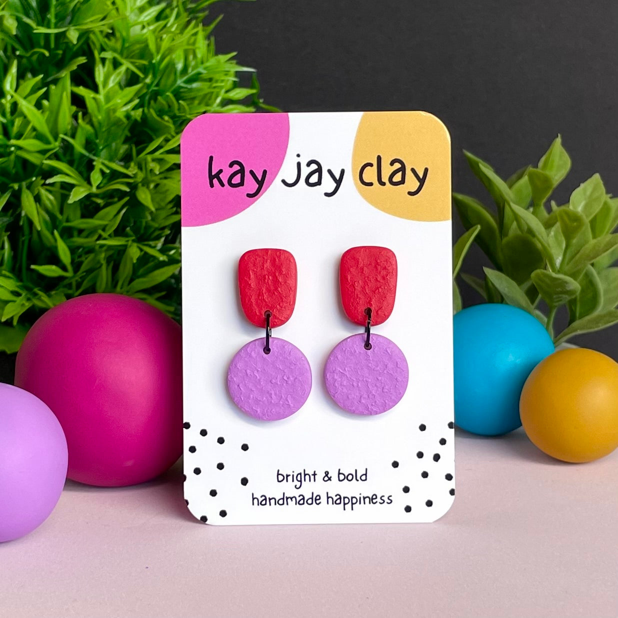 Red & Lilac colour pop dangle earrings on Kay Jay Clay branded mounting card