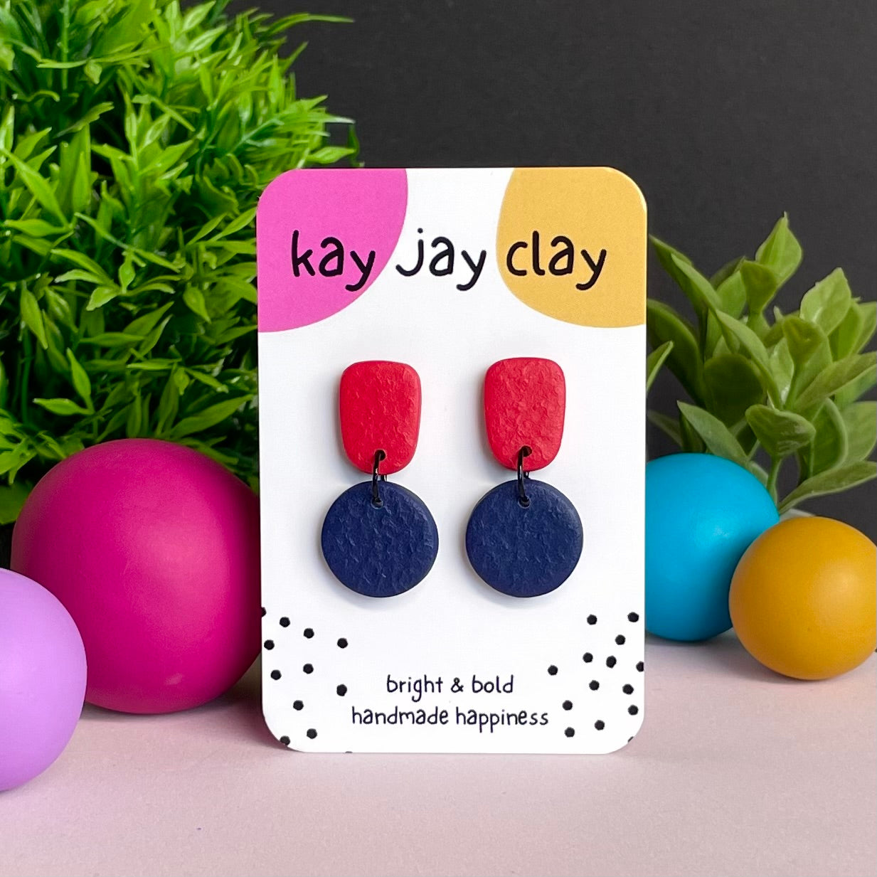 Red & Navy Blue colour pop dangle earrings on Kay Jay Clay branded mounting card