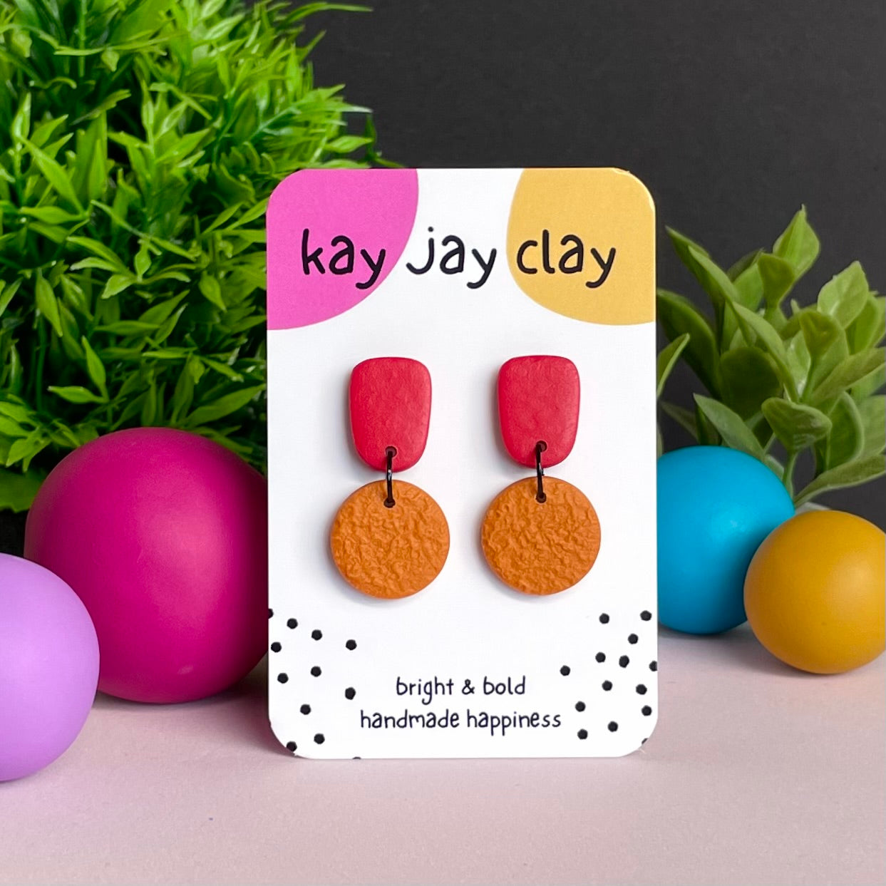 Red & Orange colour pop dangle earrings on Kay Jay Clay branded mounting card